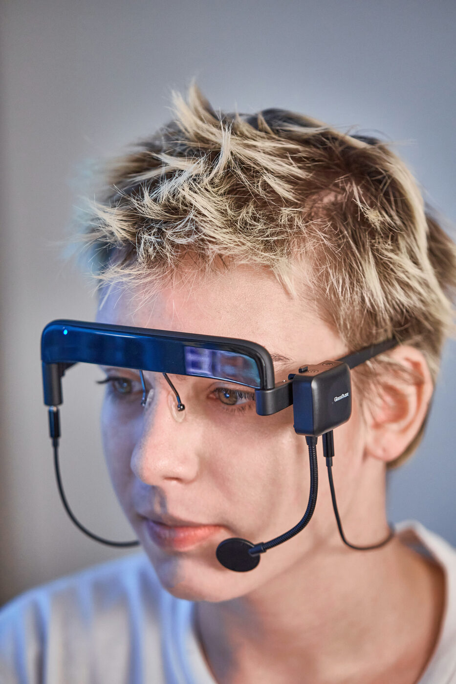 Person wearing GlassOuse V1.4 glasses frame with switch connected