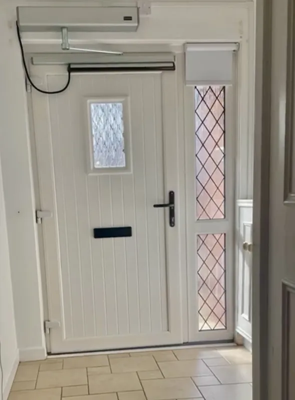 Automated door opener installed on a home front door — a real Control-NI installation